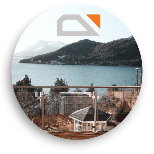 Modern glass balustrade with stainless steel posts on a terrace overlooking lake, rooftops and snow-covered mountain range