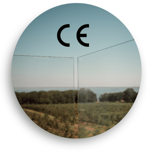 Close-up of CE-marked laminated glass designed for pool railings, offering durability and safety with open views over the Skåne countryside.