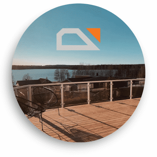 Stylish glass railing with white posts and neat end finishes on a sunny terrace with views over a peaceful lake.